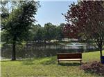 A bench next to the water with a fountain at BLAKE FARMS FAMILY RV RESORT - thumbnail