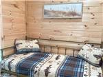 A futon bed with a trundle bed under in a rental at TRAILBLAZER RV VILLAGE - thumbnail