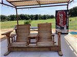 A wooden two seater rocker at OLD TOWNE RV RANCH - thumbnail