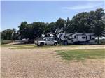 White truck and fifth wheel in a gravel site at OLD TOWNE RV RANCH - thumbnail
