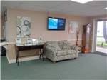 A sofa and TV inside the main office at RIO VALLEY ESTATES 55+ MOBILE/RV PARK - thumbnail
