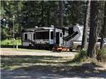 A fifth wheel parked on-site at WHISPERING PINES RV PARK - thumbnail