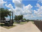 A walking path next to the paved sites at SEA GRASS RV RESORT - thumbnail