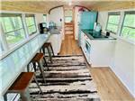 The inside of the bus conversion at DANCING FIRE GLAMPING AND RV RESORT - thumbnail