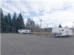 A gravel area leading to RV spots at FAR WEST RV PARK - thumbnail