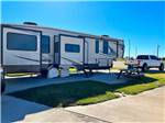 A fifth wheel parked in a paved RV site at THE RV RESORT - thumbnail