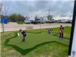 Kids playing on the mini golf course at THE RV RESORT - thumbnail