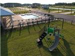 Aerial view of the swimming pool and kids playground at GRAND RIVIERA RV RESORT - thumbnail