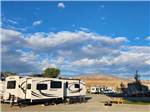 Trailers parked in gravel sites at WHISPERING RIVER RANCH RV PARK - thumbnail