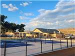 The pickle balls courts next to the clubhouse at WHISPERING RIVER RANCH RV PARK - thumbnail