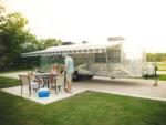 A family sitting next to their Airstream at CAMP LANDA RV RESORT - thumbnail