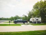 A truck and trailer parked in a site at CAMP LANDA RV RESORT - thumbnail