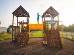 Kids playing on the wooden play structures at CAMP LANDA RV RESORT - thumbnail