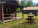 Two cabin rentals with benches at THREE RIVERS RESORT - thumbnail
