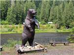 A large bear statue by the river at THREE RIVERS RESORT - thumbnail
