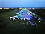 Aerial view of the filled up RV sites lit up at night at THE PALAPA RV BEACH RESORT - thumbnail