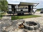 A firepit near a parked RV at ROARING RIVER HILLS CAMPGROUND AND CABINS - thumbnail