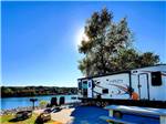 A trailer backed in with a river view at BOTEL CAMPGROUND - thumbnail