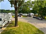 A row of trailers parked by the river at BOTEL CAMPGROUND - thumbnail