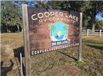 The front entrance sign and a flag at COOPER LAKE RV COMMUNITY - thumbnail