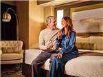 A couple drinking wine in one of the hotel rooms at SPIRIT MOUNTAIN CASINO RV PARK - thumbnail