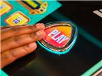 A hand pressing the Play button on a machine at SPIRIT MOUNTAIN CASINO RV PARK - thumbnail