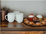 Dessert next to some cups on a shelf at BIRDIE RV PARK - thumbnail