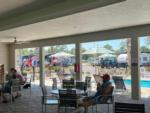 A man relaxing by the pool at SANTA FE PALMS RV RESORT - thumbnail