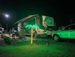 A Class A motorhome parked in a site with a palm tree light lit up at SANTA FE PALMS RV RESORT - thumbnail