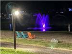 Seating to view the colorful fountain on the lake - thumbnail