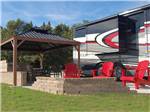 A motorhome parked in a concrete site at GATHERING PLACE RESORT & LODGE - thumbnail