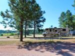 RV in a gravel site at PINE HAVEN VENUE & LODGING - thumbnail