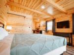 A bedroom in a rental cabin at PINE HAVEN VENUE & LODGING - thumbnail