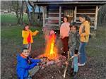 A family around a campfire at HEAVENLY HILLS NATURE RETREAT - thumbnail