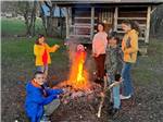 Kids roasting marshmallows at the fire pit at HEAVENLY HILLS NATURE RETREAT - thumbnail