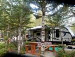 Trailer in treed site with picnic table - thumbnail