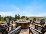 Adirondack chair seating around a fire pit at BLACK HILLS VISTA RV PARK - thumbnail