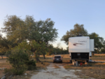 Vehicle and RV in grass site at Homestead Hill - thumbnail