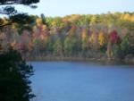 Lake with fall trees at The Woodlands Acres Campground - thumbnail