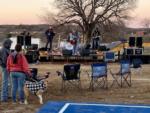A couple and dog listening to a band play at FLYING HORSE RV PARK - thumbnail
