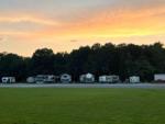 A view of RVs parked at sunset at THE LANDING STRIP CAMPGROUND - thumbnail