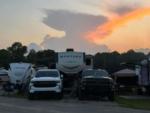 RVs parked in sites at sunset at THE LANDING STRIP CAMPGROUND - thumbnail