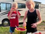 Two kids eating watermelon at THE LANDING STRIP CAMPGROUND - thumbnail