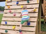 A boy climbing on the playground at THE LANDING STRIP CAMPGROUND - thumbnail