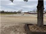 A row of paved sites with benches at MIDWAY RV PARK AND CABIN RENTALS - thumbnail