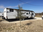 Trailer in a gravel site at Open Valley RV Park - thumbnail