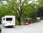 An RV with slide-outs in a shady site - thumbnail