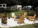 Adirondack chairs around a fire pit at St John's Campground - thumbnail