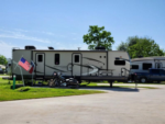 RV with motorcycle parked in front at Jackie's Place RV Resort - thumbnail