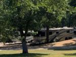 A motorhome and trailer parked in sites at GONE FISHING RV RESORT - thumbnail